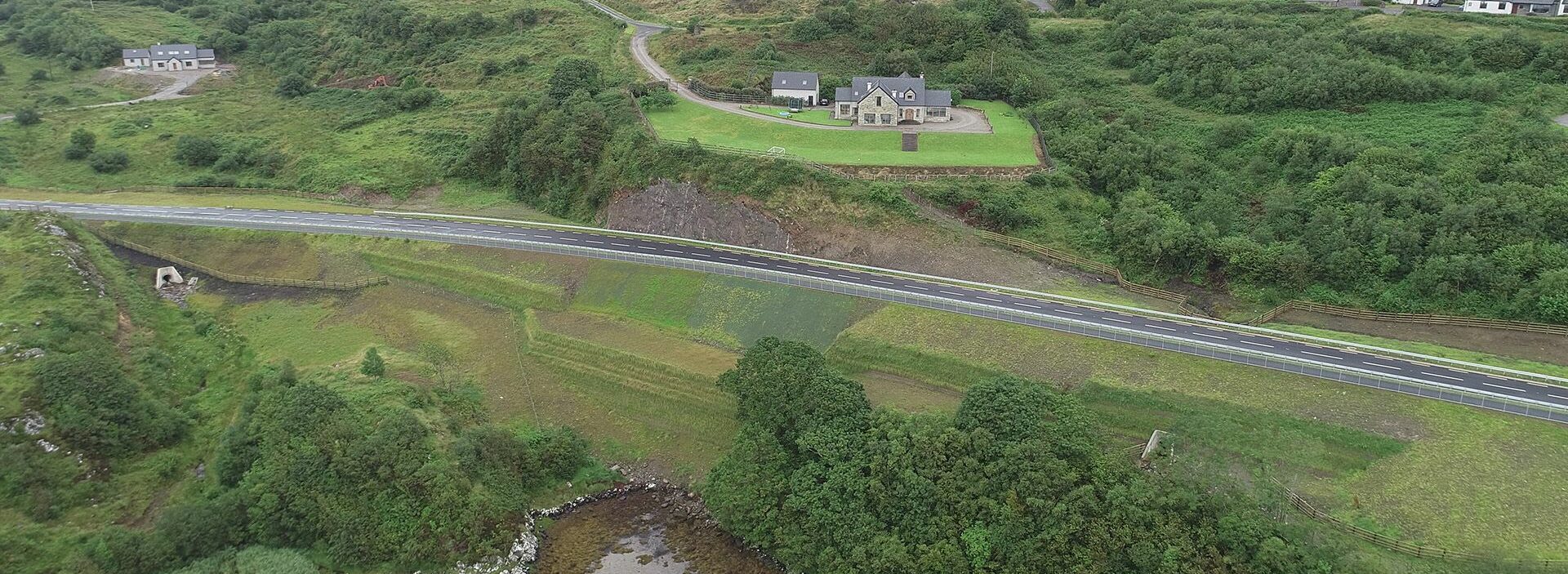 An image of a road by a waterway