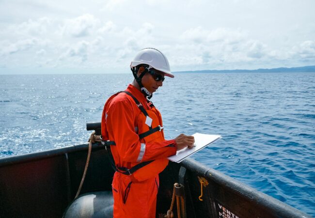 An image of a surveyor on a ship at sea
