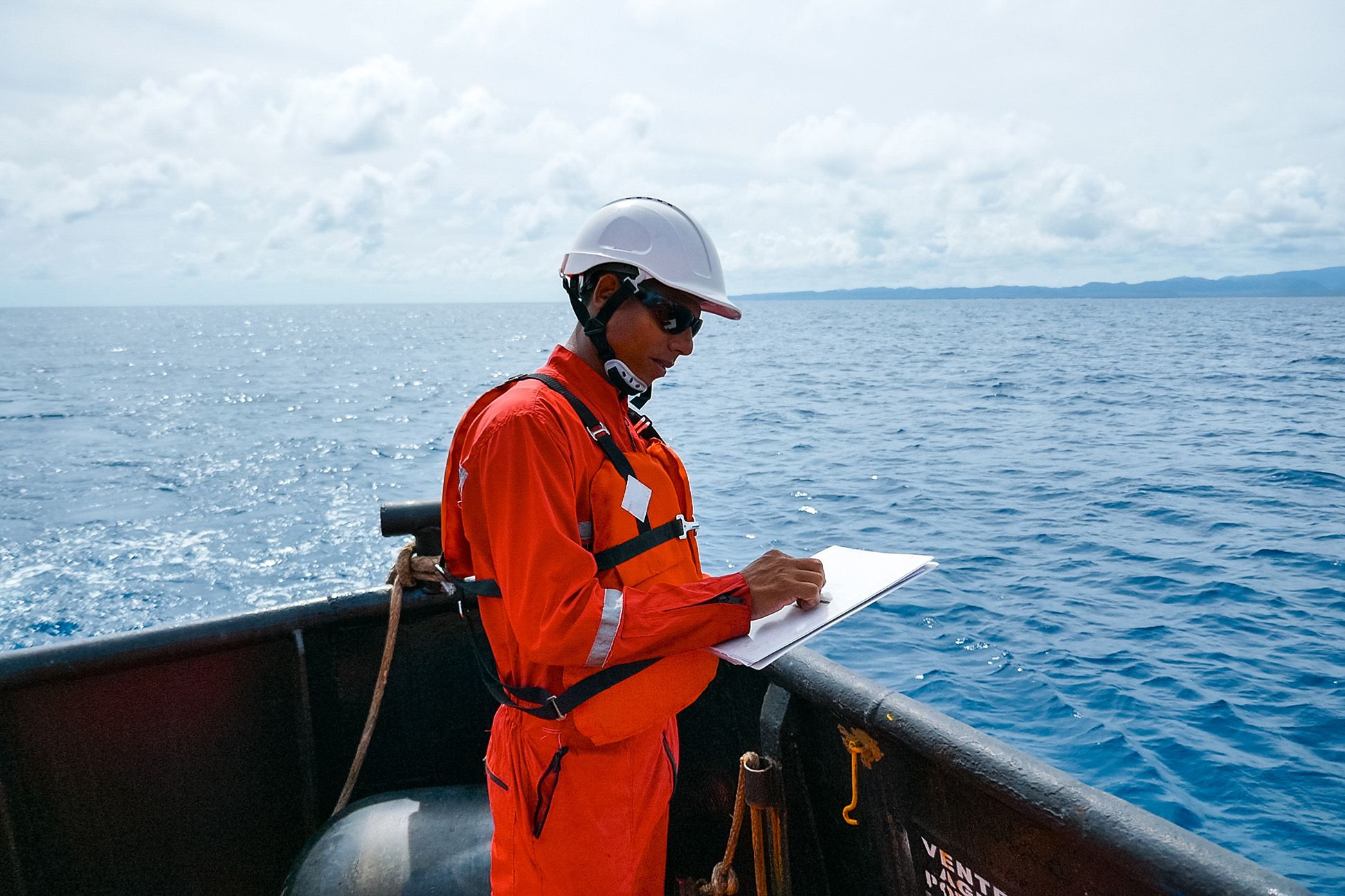 An image of a surveyor on a ship at sea