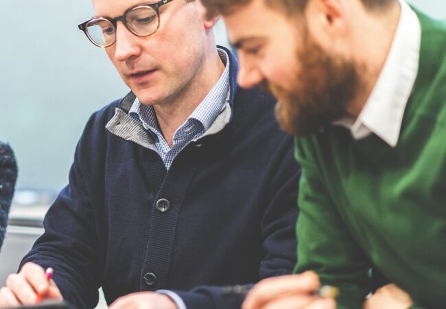 An image of GDG staff sat at a table talking